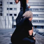 Boxeur sprinte sur les marches à Paris 13, femme épuisée au premier plan après la séance de boxe.